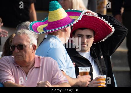 Windsor, Berkshire, UK. 19th August, 2024. It was a breezy evening with intermittent sunshine as racegoers enjoyed the Mexican themed horse racing Final Fiesta at Royal Windsor Racecourse in Windsor, Berkshire. Some racegoers got into the Mexican theme by wearing sombreros. Credit: Maureen McLean/Alamy Live News Stock Photo