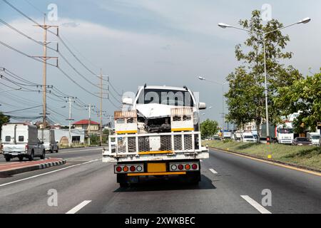 Rear of tow truck loading broken car of crash accident on highway road Stock Photo