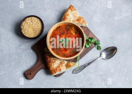 Barley noodle soup with chicken and tomato sauce, turkish traditional cuisine Stock Photo