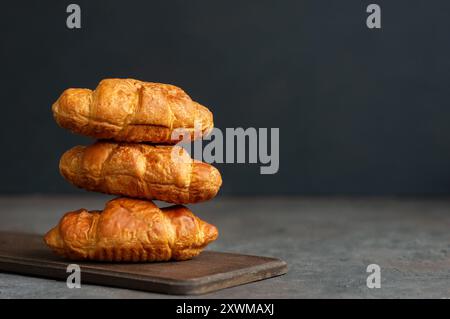 Close up Fresh baked croissants on cutting board Stock Photo