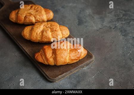 Close up Fresh baked croissants on cutting board Stock Photo