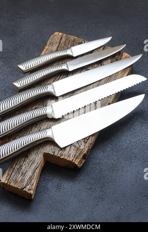 Casting steel various chef knife, Set of modern sharp kitchen knives on dark background Stock Photo
