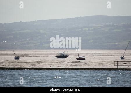 View of the North Wales coast from West Kirby, with sail boast on the River Dee Estuary Stock Photo