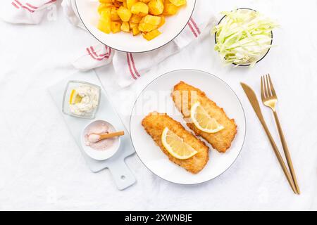 Crispy breaded fish with dipping sauce and lemon Stock Photo