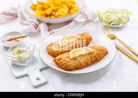 Crispy breaded fish with dipping sauce and lemon Stock Photo