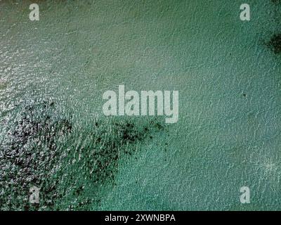 Crystalline water of Ko Ra Wi, near Koh Lipe, with the reflection of the sun and the white sand underneath Stock Photo