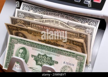 Old Philippine money - peso in the counting machine Stock Photo