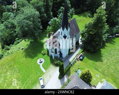 An aerial view of Kuratienkirche Meschach surrounded by lush greenery. Gotzis, Austria Stock Photo