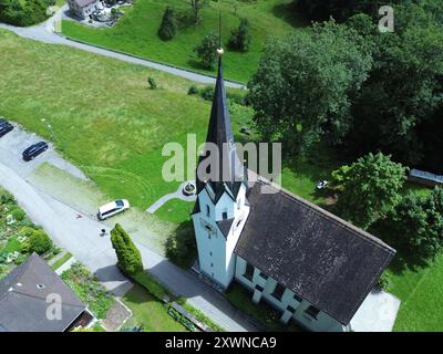 An aerial view of Kuratienkirche Meschach surrounded by lush greenery. Gotzis, Austria Stock Photo