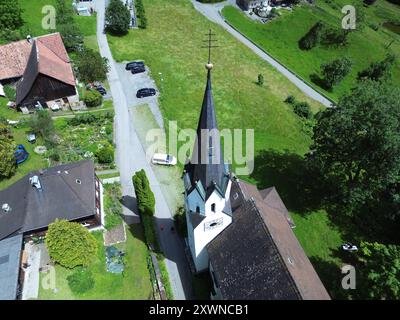 An aerial view of Kuratienkirche Meschach surrounded by lush greenery. Gotzis, Austria Stock Photo