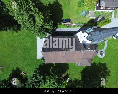 An aerial view of Kuratienkirche Meschach surrounded by lush greenery. Gotzis, Austria Stock Photo