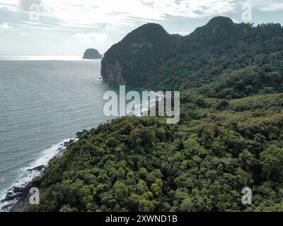Aerial view of the tropical forest and limestone mountains from the Charlie Beach on Koh Mook on a cloudy day during the rainy season Stock Photo