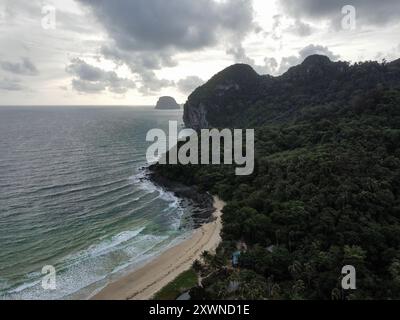 Aerial view of the tropical forest and limestone mountains from the Charlie Beach on Koh Mook on a cloudy day during the rainy season Stock Photo