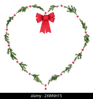 Christmas  heart wreath with fir, red bow and winter holly berries on white. Solstice decorative symbol of love for holiday season, gift tag Stock Photo