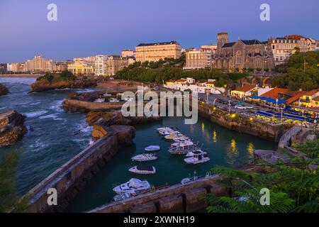 Harbour of Biarritz illuminated at dusk in summer season, Biarritz, Bayonne, New Aquitaine, Atlantic Pyrenees, France, Europe Stock Photo