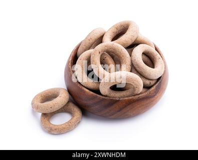 Small  whole grain bagels in wooden bowl isolated on white Stock Photo