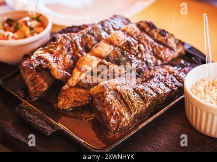 Grilled Picanha, traditional Brazilian beef cut. Meat served on the plate, luxury dinner. Stock Photo