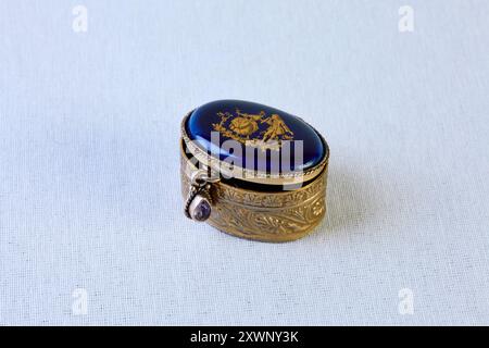 Antique jewelry box. Blue stone lid with a pattern. Antique handmade jewelry box with ornaments, chain, and pendant Stock Photo
