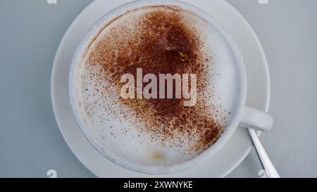 A cup of Cappuccino with cocoa. Stock Photo