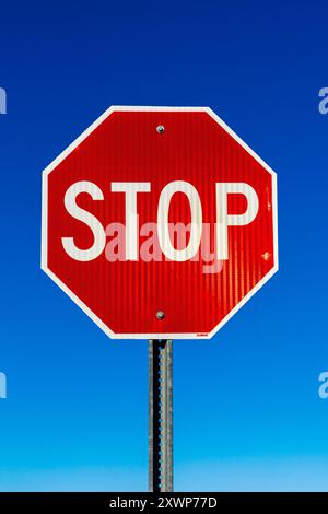 Stop sign against blue sky Stock Photo