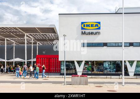Tourists in family head for the entrance of the IKEA Museum in Älmhult, Sweden, tracing the history of the flat-pack furniture company. Stock Photo