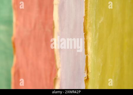Empty grungy weathered pastel multicolored cardboard  background with narrow depth of field.Rough grungy scratched and torn ripped edges, free copy sp Stock Photo