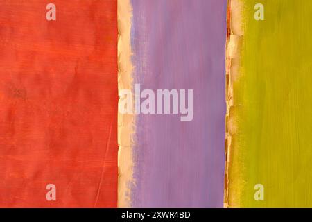Empty grungy weathered pastel multicolored cardboard  background with narrow depth of field.Rough grungy scratched and torn ripped edges, free copy sp Stock Photo