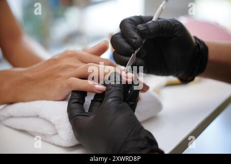 Performing Manicure Focusing on Nail Detail with Precision Stock Photo