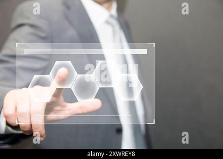 businessman making decision in business by pushing on one hexagonal button. Businessman hand pushing digital screen Stock Photo