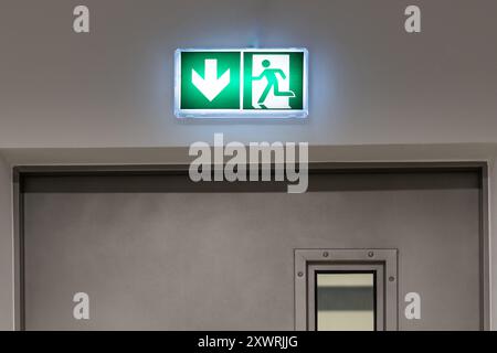 emergency exit sign nad drzwiami above the door Stock Photo