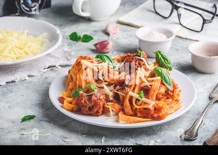 Pasta with mini meatballs, tomato sauce and parmesan cheese Stock Photo