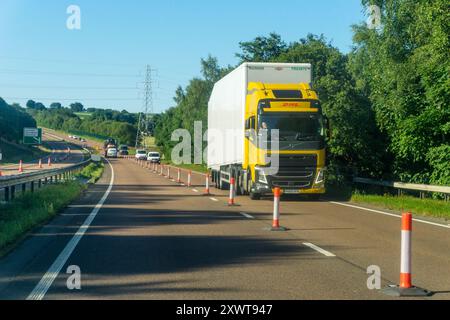 Oncoming traffic in contra-flow section of dual carriageway road, only separated by bollards.  A9 dual carriageway outside Forfar. Stock Photo