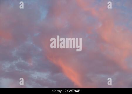 Pretty pink clouds against a blue sky at sunset Stock Photo