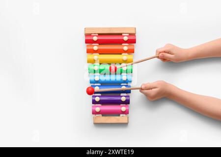 Child's hands with xylophone on white background Stock Photo