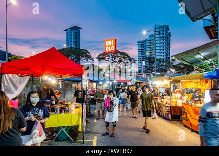 A street market selling primarily street food and drink at Market Complex in Tanjung Bunghah, Penang, Malaysia at sunset with lights glowing Stock Photo