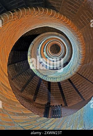 Spiral stairway, seen from above, descending. Entirely done in brick masonry. Photographed in Haarlem, the Netherlands. Stock Photo