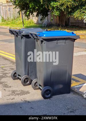 Two Large Plastic Wheeled Wheelie Bins Placed on a Roadside Stock Photo