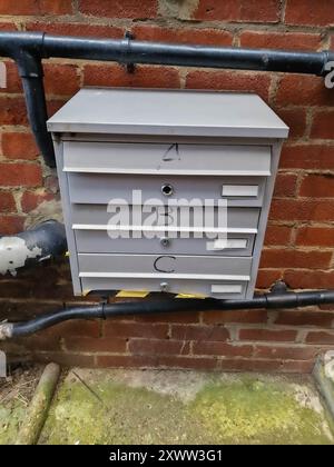Wall-Mounted Multibox Apartment Mailboxes on a Brick Exterior Stock Photo