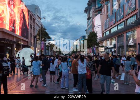 Beijing, China - August 12, 2024: A steady flow of tourists on Wangfujing Pedestrian Street in Beijing Stock Photo