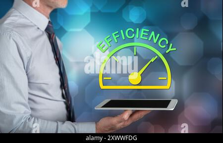 Efficiency concept above a tablet held by a man Stock Photo