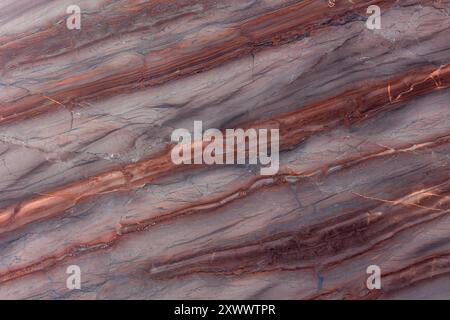 High-quality image of quartzite stone texture featuring distinctive red and grey streaks. Stock Photo