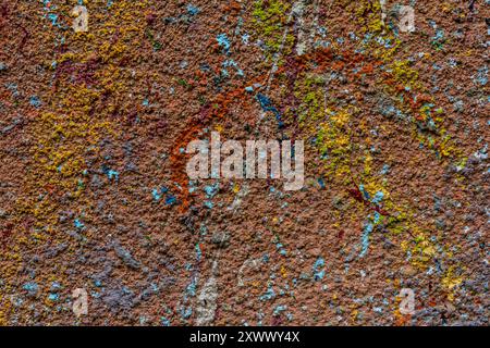 White plastered wall splattered with red paint. Paint splashes on the wall. Painted plaster wall. Abstract background. Painted plaster texture. Stock Photo