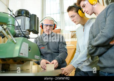 engineer and apprentices using automated milling machine Stock Photo