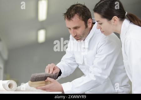 a painter with a female apprentice Stock Photo