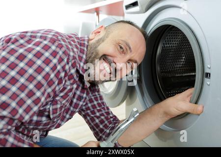 woman looking at washing machine Stock Photo