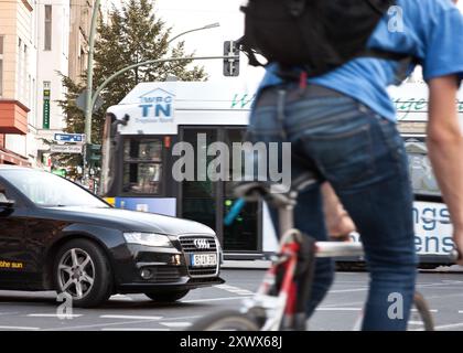 A busy rush hour scene at U-Bahnhof Eberswalderstr in Berlin's Prenzlauer Berg. The image captures the hectic traffic with cars, bicycles, and pedestrians navigating the bustling urban intersection. Stock Photo