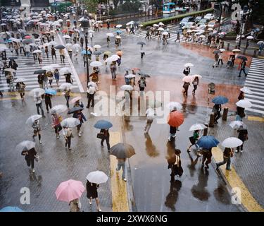 Pedestrians walk at Shibuya Crossing during the holiday season. The ...