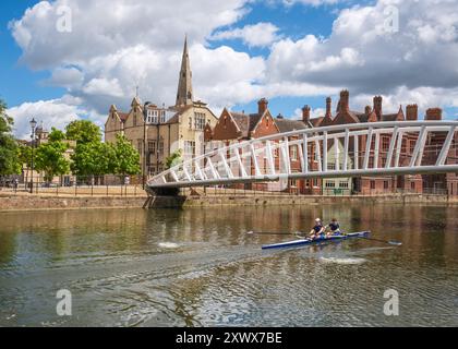 Bedford, England - 8th July 2024: Two rowers training in a double scull pass under the Riverside Bridge over the river Great Ouse in the town of Bedfo Stock Photo