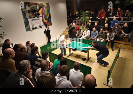 Crowd watching the final match of the 20th East German Sectional Table Football Championship at the Berliner Tip-Kick Club. The intense game between Wagner and Winckelmann captivates the audience. Stock Photo