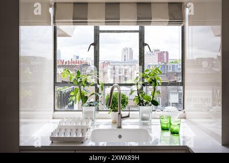 View of London skyline from kitchen window of modern apartment, UK. Stock Photo